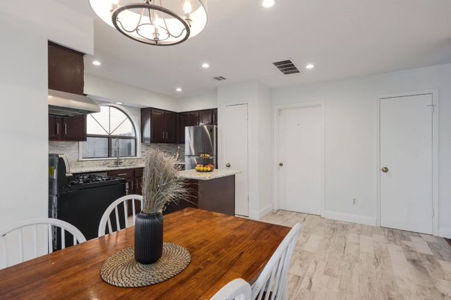 Serving meals from the kitchen to the dining room is a breeze, with the open layout allowing you to effortlessly transition from cooking to enjoying the meal | Image 13