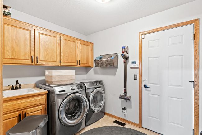 Very functional laundry area off the garage with more storage! There is also a closet in this room. | Image 27