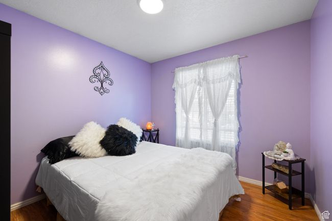 Bedroom with hardwood / wood-style floors | Image 22