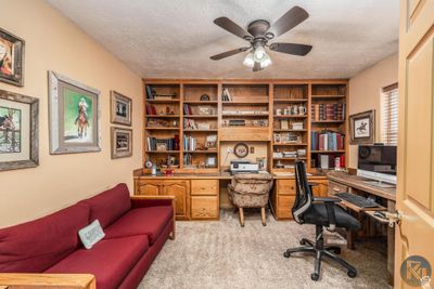 Office area with light carpet, a textured ceiling, and ceiling fan | Image 3