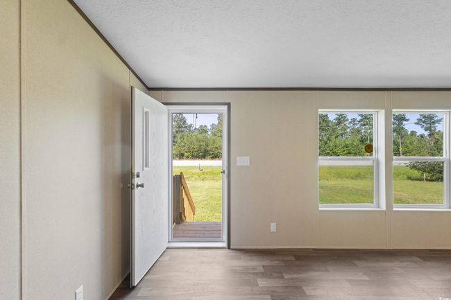 Entryway featuring wood finished floors and a textured ceiling | Image 8