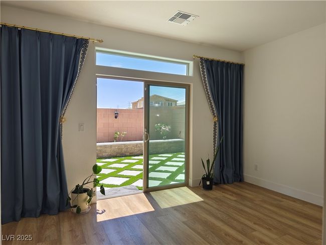 Bedroom downstairs with large sliding doors to backyard access and views | Image 20