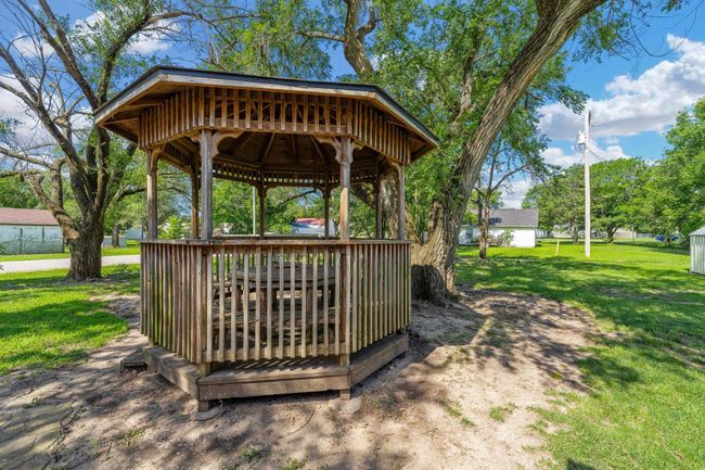 Wooden terrace with a gazebo and a lawn | Image 32