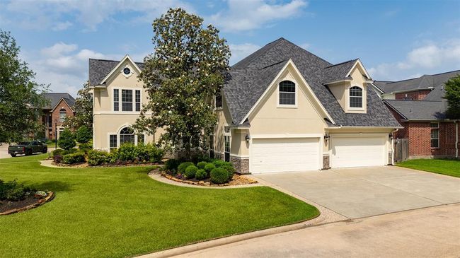 An expansive 4-car garage sits along the side of the home — ideal for car enthusiasts, extra storage, or even a home gym or workshop. The space, accessibility, and versatility are unmatched. | Image 8