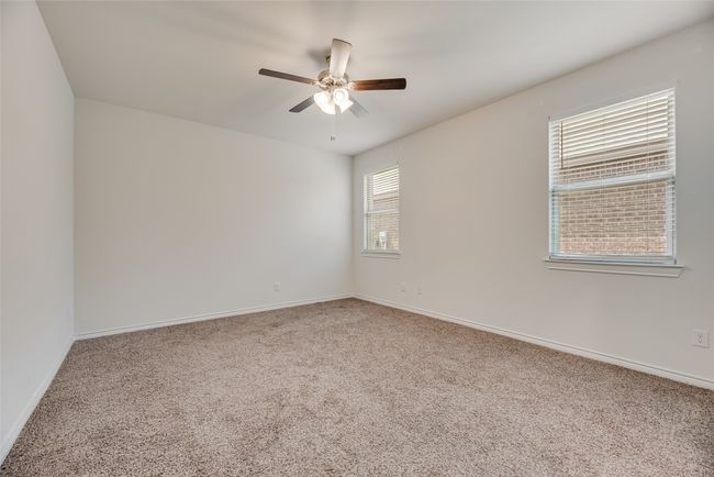 Empty room featuring carpet, a ceiling fan, and baseboards | Image 22