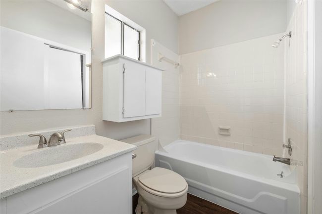 Bathroom with shower / bathing tub combination, wood finished floors, vanity, and toilet | Image 19
