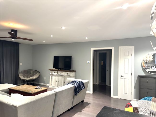 Living room with a ceiling fan, wood finished floors, and recessed lighting | Image 7