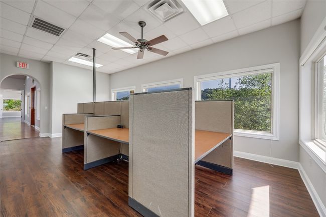 Unfurnished office with arched walkways, hardwood / wood-style floors, and visible vents | Image 18