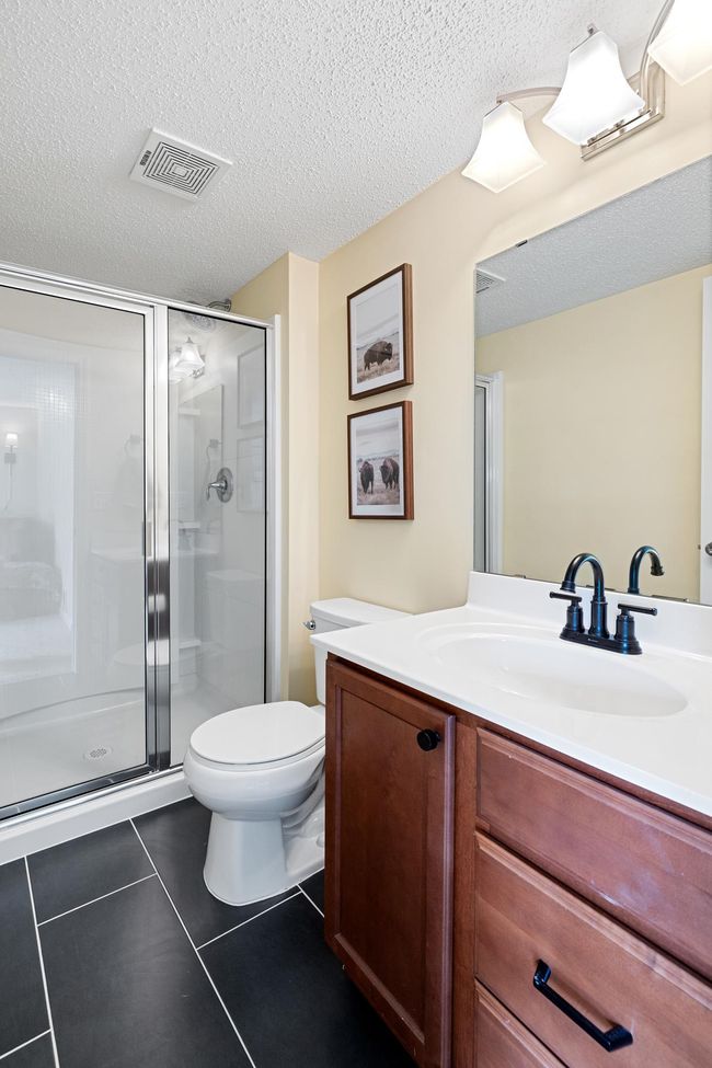 Basement bathroom with new tile floors and walk-in shower. | Image 26