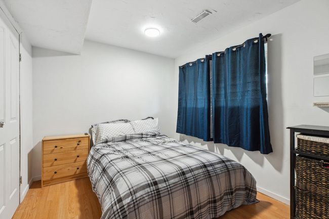 Bedroom with visible vents, baseboards, and wood finished floors | Image 26