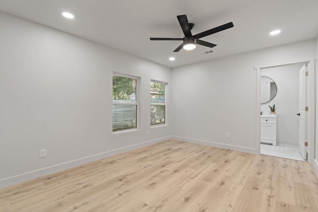 Empty room featuring light wood-style flooring, ceiling fan, recessed lighting, and baseboards | Image 17