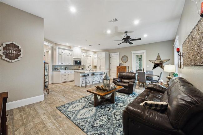 This home offers a separate, wheelchair-accessible in-law suite with its own front door and access to a three-car tandem garage. It includes an office, half bathroom, living and dining areas, breakfast bar, private door to a covered patio, two oversized walk-in closets, and a spacious primary bedroom with a full bathroom. Perfect for multigenerational living or guests. | Image 36