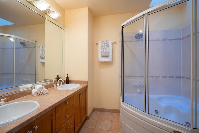 Full bathroom featuring bath / shower combo with glass door, tile patterned flooring, baseboards, and a sink | Image 19