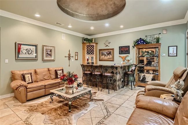 Living room featuring recessed lighting, visible vents, a dry bar, and crown molding | Image 16