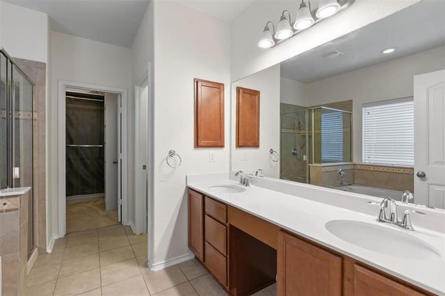 Primary Bathroom with walk in shower and soaking tub. Double Vanities and built in medicine chest. Walk in closet | Image 16