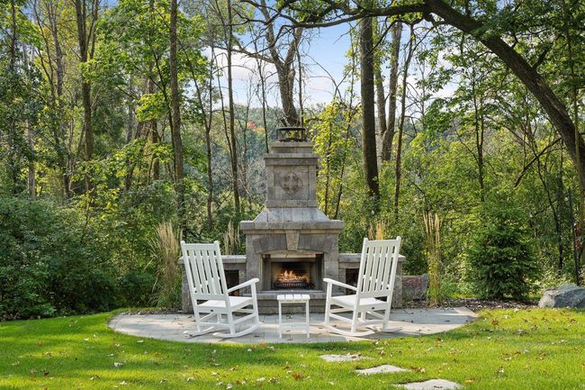 Grand Outdoor Fireplace with Patio seating | Image 55