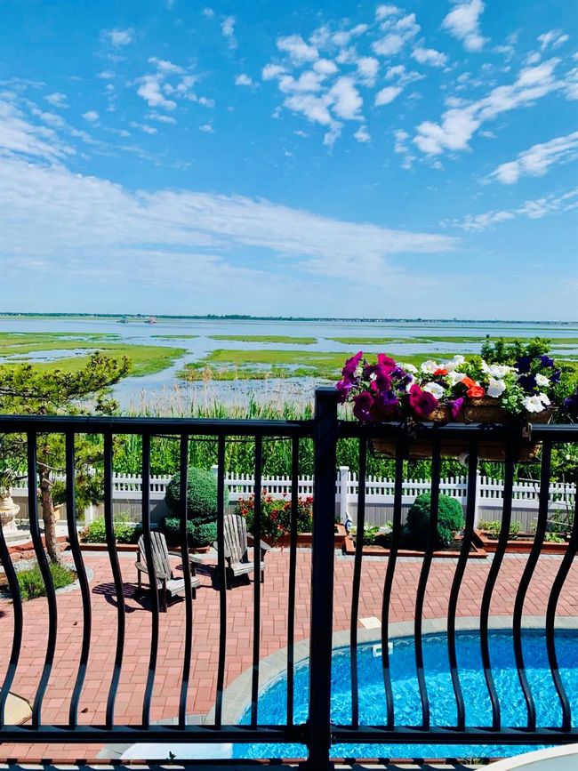 Balcony with a water view and a patio | Image 15
