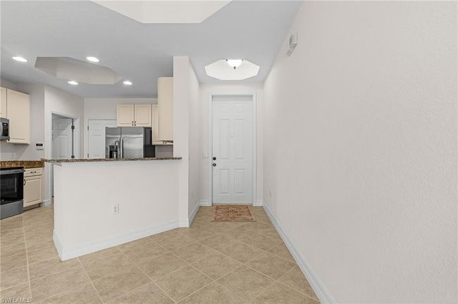 Kitchen featuring appliances with stainless steel finishes, recessed lighting, a peninsula, and light tile patterned flooring | Image 5