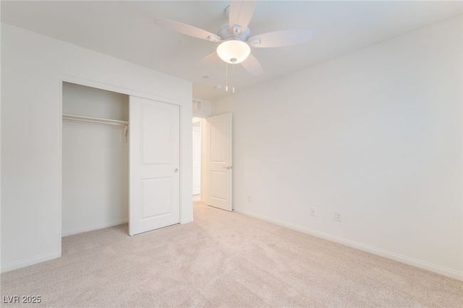 Unfurnished bedroom featuring light colored carpet, a closet, and ceiling fan | Image 27