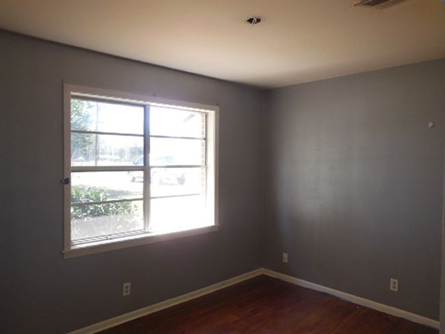Empty room with baseboards and dark wood finished floors | Image 9