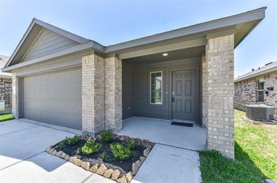 The exterior of the home combines brickwork with siding, offering a contemporary look. | Image 2