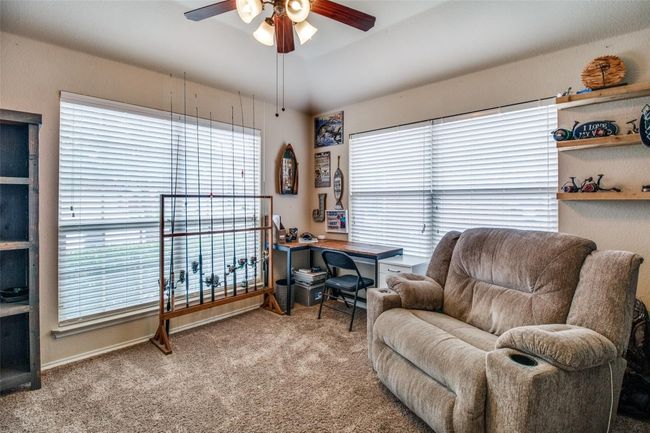 Carpeted office space with ceiling fan, plenty of natural light, and baseboards | Image 13