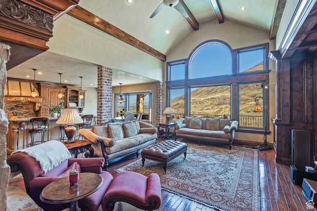 Living room with high vaulted ceiling, hardwood / wood-style flooring, beamed ceiling, and a ceiling fan | Image 14