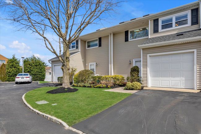 Multi unit property with a front yard and driveway | Image 22