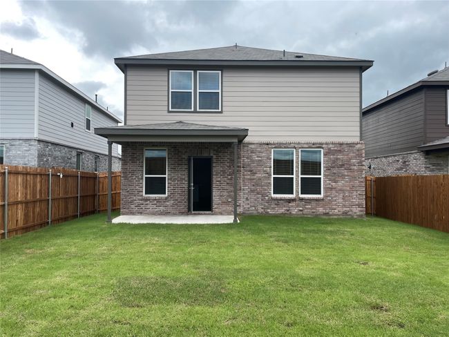 Rear view of property featuring a patio area, brick siding, and a shingled roof | Image 24