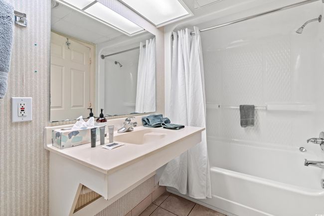 Full bath with shower / bathtub combination with curtain, tile patterned flooring, and vanity | Image 10