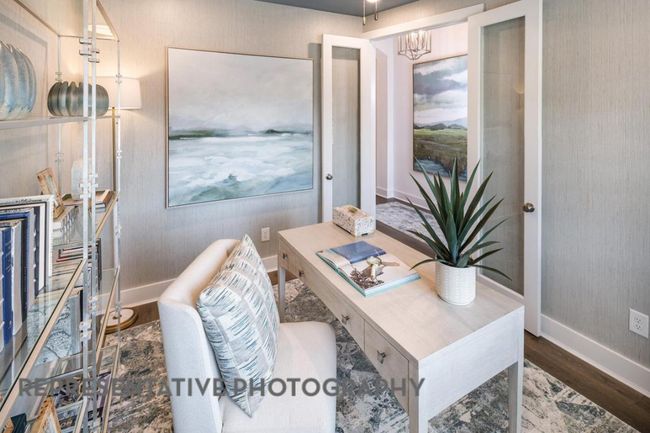 Office area with a chandelier and wood finished floors | Image 25