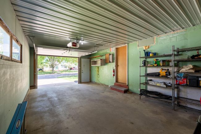 Oversized, insulated one car garage with front and back service door. | Image 32