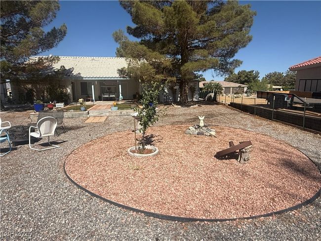 View of yard with a fire pit and a patio area | Image 65
