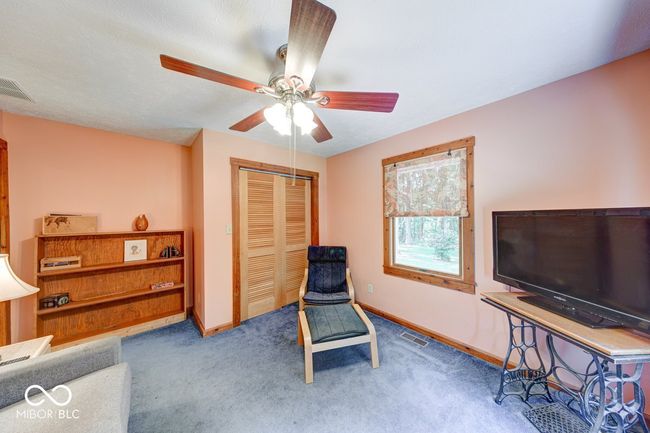 sitting room with ceiling fan and carpet flooring | Image 34