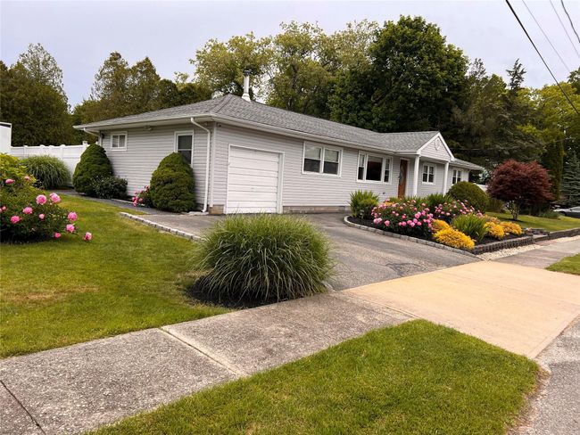 Ranch-style house with a garage and asphalt driveway | Image 4