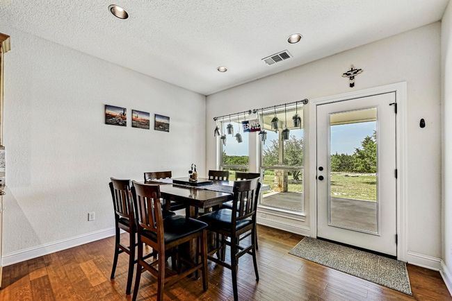 Dining space with dark wood-style floors and recessed lighting | Image 14
