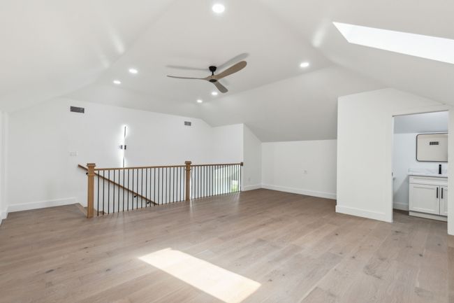 So many options for this second living area. Beautiful natural light with skylight and half bath. | Image 29