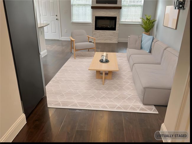 Staged Living area with wood finished floors, healthy amount of natural light, and a fireplace | Image 4