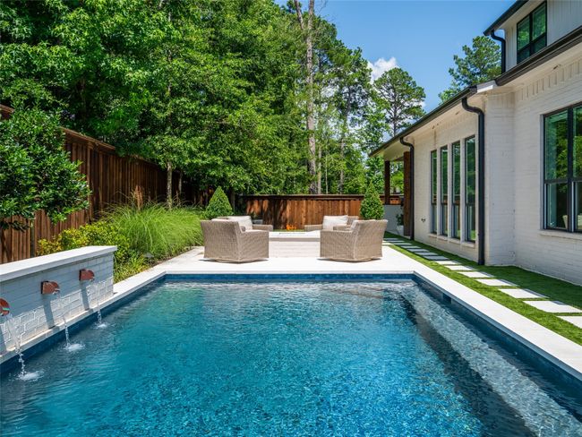 View of pool with an outdoor living space and a fenced backyard | Image 40