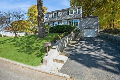 View of front facade featuring a front yard and a garage | Image 2