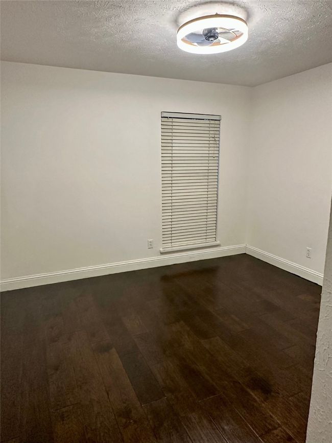 Secondary room with a textured ceiling and dark wood-style flooring | Image 27