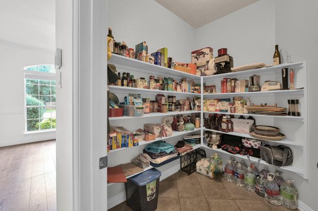 The expansive walk-in pantry offers exceptional storage for all your kitchen essentials and more! | Image 17