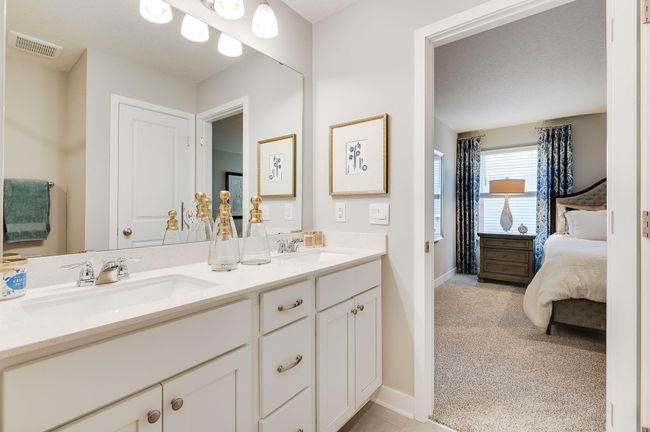 In addition to the space provided in the primary bedroom, the attached bath provides a true oasis to come home to, featuring a double vanity and stand-in shower. Photo of model, colors and options will vary. | Image 13
