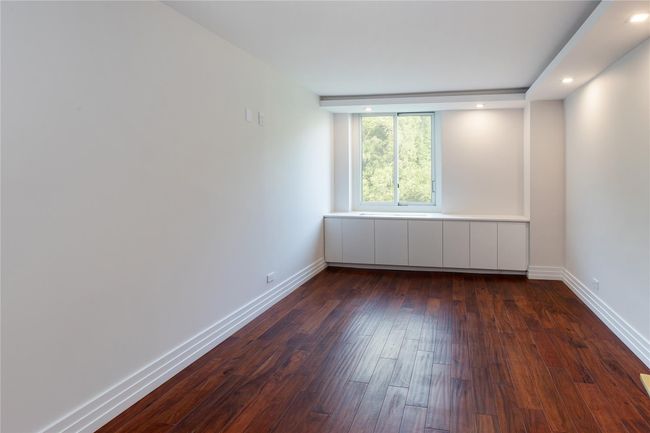 Spare room featuring dark wood-style flooring and recessed lighting | Image 14