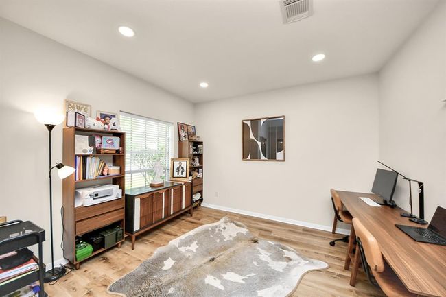 The flex space at the front of the house features a large window that fills the room with natural light, offering endless possibilities. | Image 9