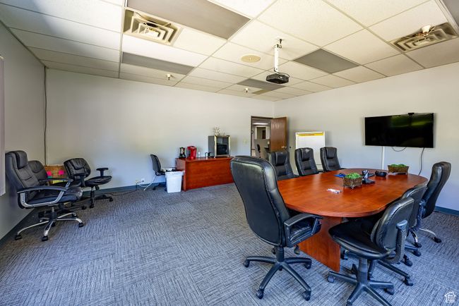 Home office with a paneled ceiling and carpet | Image 13