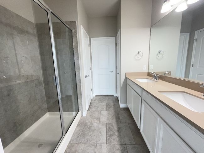 Full bathroom with double vanity and a stall shower | Image 13
