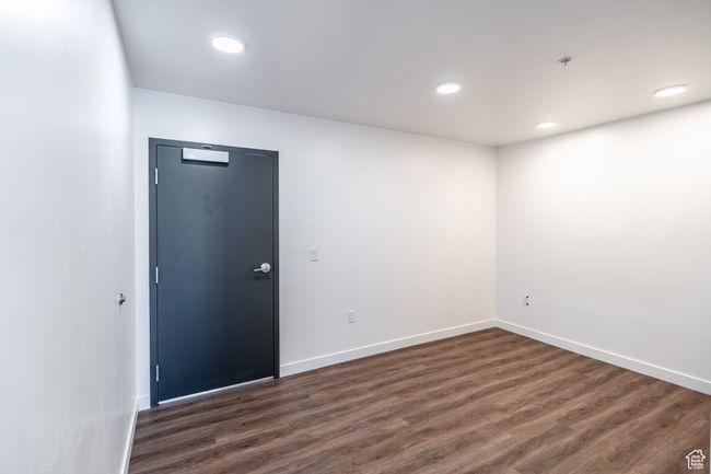 Spare room featuring recessed lighting, baseboards, and dark wood finished floors | Image 11