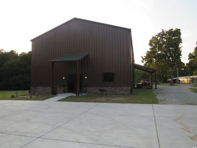 View of outdoor structure featuring a carport and a yard | Image 1