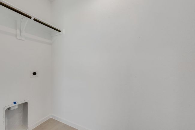 Laundry area with electric dryer hookup and light wood-style flooring | Image 15